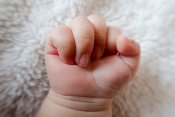 baby hand and finger on the white carpet background