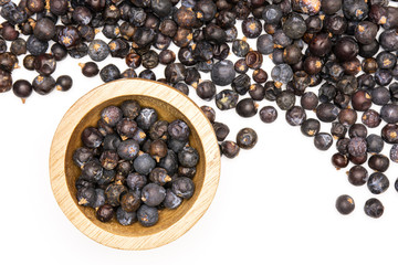 Lot of whole dry juniper berry seed flatlay isolated on white background