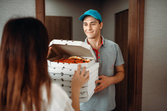 Delivery man shows pizza to customer at the door