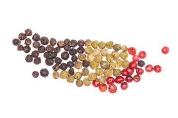 Lot of whole peppercorns of four colors flatlay isolated on white background