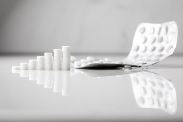 Growth graph made of stacked white pills - growing market and increasing demand for white pill and it's substitutes