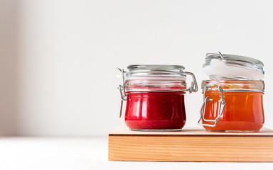 Two jars of jam on a white background. Copy space.