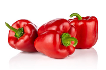 Group of three whole bulgarian red bell pepper isolated on white background