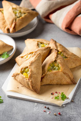 Tatar pie triangle echpochmak, Russian kurnik, delicious pastry with chicken and potatoes. Traditional food, quick snack of dough © maria_lapina