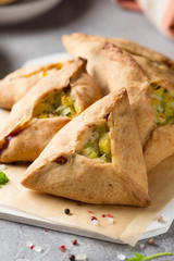 Tatar pie triangle echpochmak, Russian kurnik, delicious pastry with chicken and potatoes. Traditional food, quick snack of dough © maria_lapina