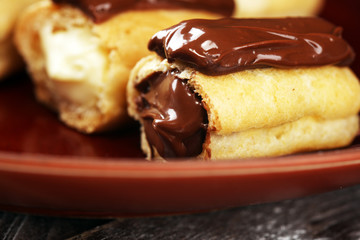 Traditional French dessert. Eclair with chocolate icing. Pastery concept with chocolate eclair