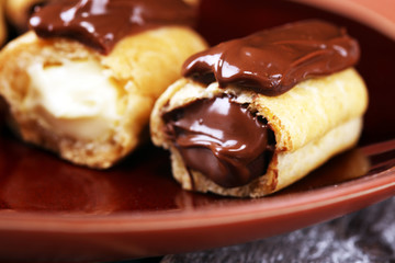 Traditional French dessert. Eclair with chocolate icing. Pastery concept with chocolate eclair