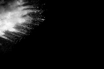 Abstract white powder explosion against black background.White dust exhale in the air.