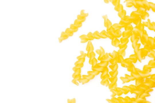 Lot of pieces of raw italitan yellow pasta torti flatlay isolated on white background
