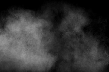 Fototapeta na wymiar Abstract white powder explosion against black background.White dust exhale in the air.