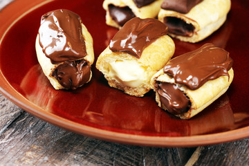 Traditional French dessert. Eclair with chocolate icing. Pastery concept with chocolate eclair