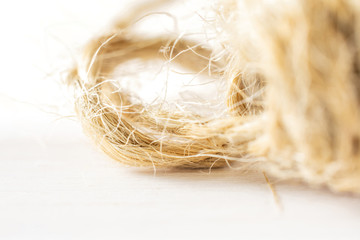 Closeup of jute rope on white wood