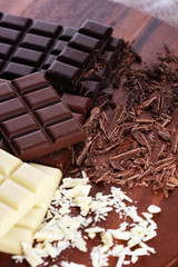 chocolate in diffrent color. milk, dark and white chocolate bars on table