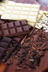 chocolate in diffrent color. milk, dark and white chocolate bars on table