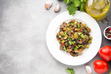 Vegetable stew with eggplant, zucchini, tomatoes, onions, mushrooms, garlic and cilantro. Vegetarian ajapsandali, Italian caponata. Traditional saute Ratatouille