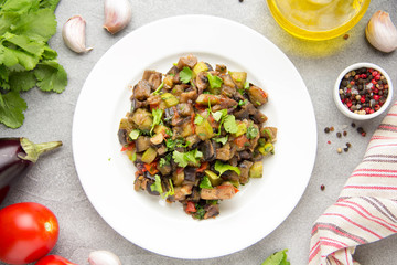 Vegetable stew with eggplant, zucchini, tomatoes, onions, mushrooms, garlic and cilantro. Vegetarian ajapsandali, Italian caponata. Traditional saute Ratatouille