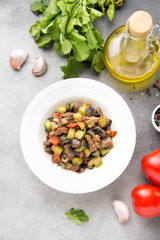 Vegetable stew with eggplant, zucchini, tomatoes, onions, mushrooms, garlic and cilantro. Vegetarian ajapsandali, Italian caponata. Traditional saute Ratatouille