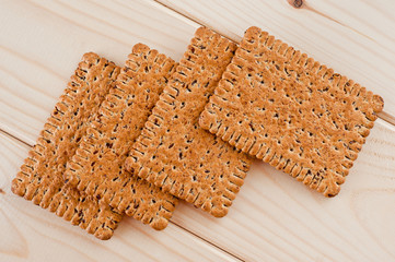 Dieting cookies with flax seeds and sunflower seeds and cracknels on the background
