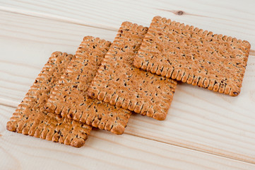 Dieting cookies with flax seeds and sunflower seeds and cracknels on the background