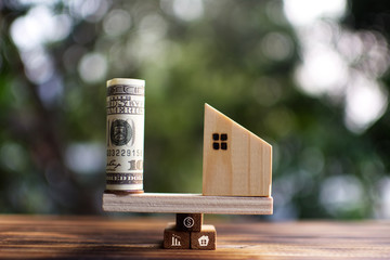 Little wood house model and banknote on plank start to protect the residential .