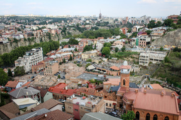 Fototapeta na wymiar View of the city from the observation deck. The capital of Georgia is Tbilisi. Old city. The Kura River. Red roofs, low buildings. Panorama, architecture, urban