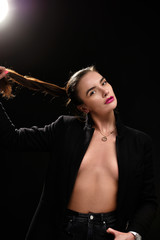 Fototapeta premium Portrait of beautiful sexy brunette girl on a black background