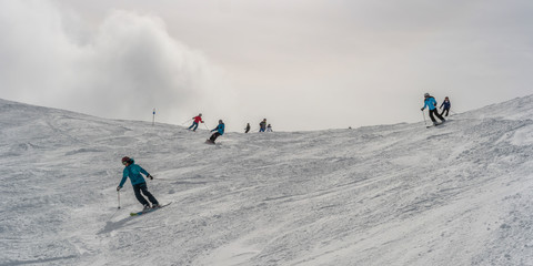 Tourists downhill skiing, Whistler, British Columbia, Canada