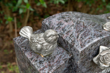 Spatz auf einem Grabstein