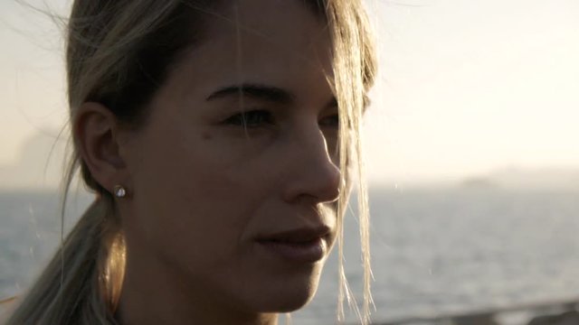 Young women doing exercises at sea port. Close-up of fit blond caucasian woman on sunset sea background