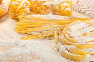 Raw yellow italian pasta pappardelle, fettuccine or tagliatelle