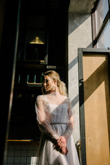 Fototapeta na wymiar Bride in white wedding dress posing indoors