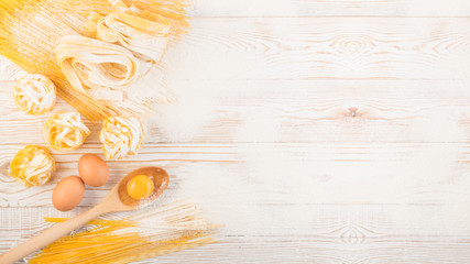 Raw yellow italian pasta pappardelle, fettuccine or tagliatelle