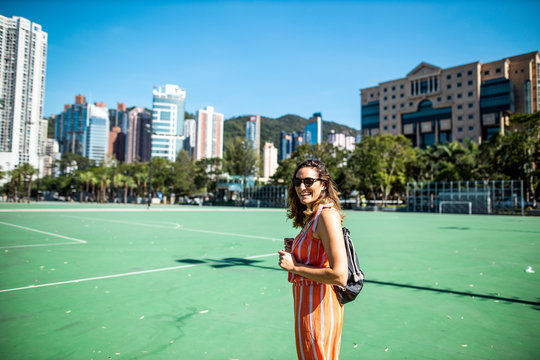 Hong Kong, Causeway Bay, Victoria Park, portrait of laughing woman on a sports field