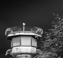 Watchtower of a correctional facility of a prison with a balustrade and two rows of barbed wire...