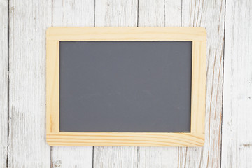 Blank chalkboard on weathered whitewash textured wood background