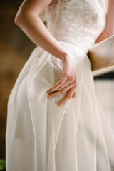 Hand on a white dress. Advertising of wedding dresses