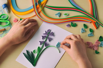 Quilling technique. Making decorations or greeting card. Paper strips, flower, scissors. Handmade...