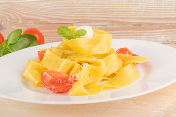 Yellow italian pasta pappardelle, fettuccine or tagliatelle