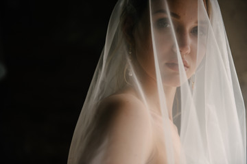 Bride posing close up in a veil