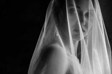 Bride posing close up in a veil