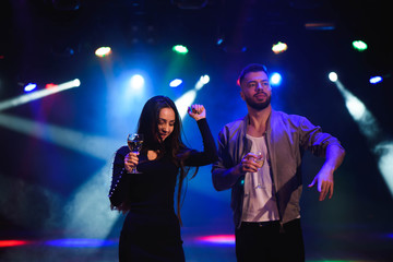 Young stylish couple flirting in the nightclub