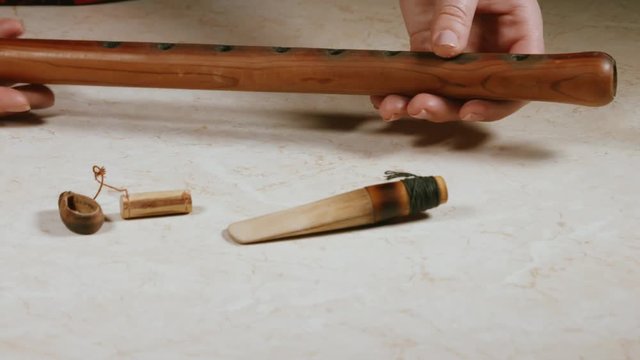 close-up of women's hands with the national Armenian wooden wind instrument DUDUK