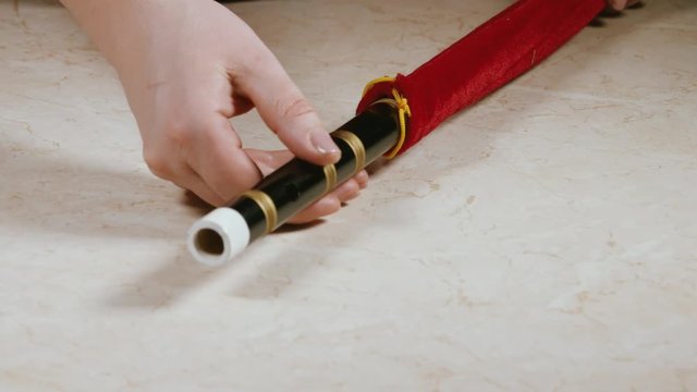 close-up of female hands with national Chinese woodwind instrument flute Di