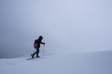 Woman doing sports, advances in the mountains in the middle of a great snow, Irati, Pyrenees, Navarra