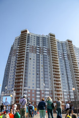 a crowd of people watching a man on the roof