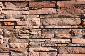 Naklejka premium Smooth laying of natural stone. Beautiful background of the facade.