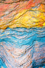 Colourful sedimentary rocks formed by the accumulation of sediments – natural rock layers backgrounds, patterns and textures - abstract graphic design – geology – nature formations