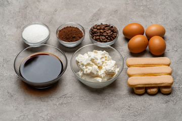 Ingredients for cooking tiramisu - Savoiardi biscuit cookies, mascarpone, cheese, sugar, cocoa, coffee and egg