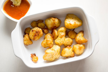 Cauliflower popcorn, coated mini cauliflower florets in a light batter with a spicy Buffalo dip