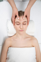 close-up masseur hands doing back massage in spa center. high key photo